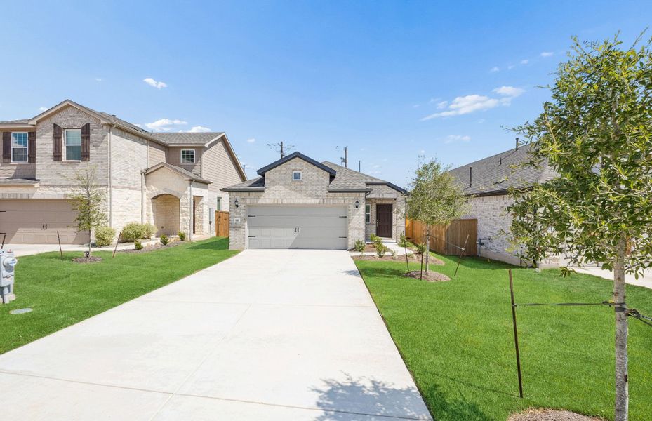 Front exterior of a new home in Crosswinds, Kyle, TX, highlighting curb appeal (Image 17).