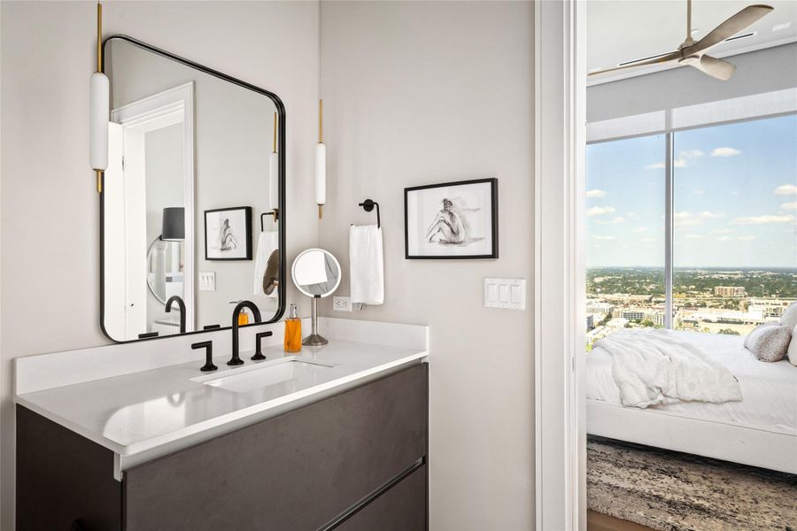 Secondary ensuite bath featuring Pedini cabinetry, quartz countertops, and designer lighting.