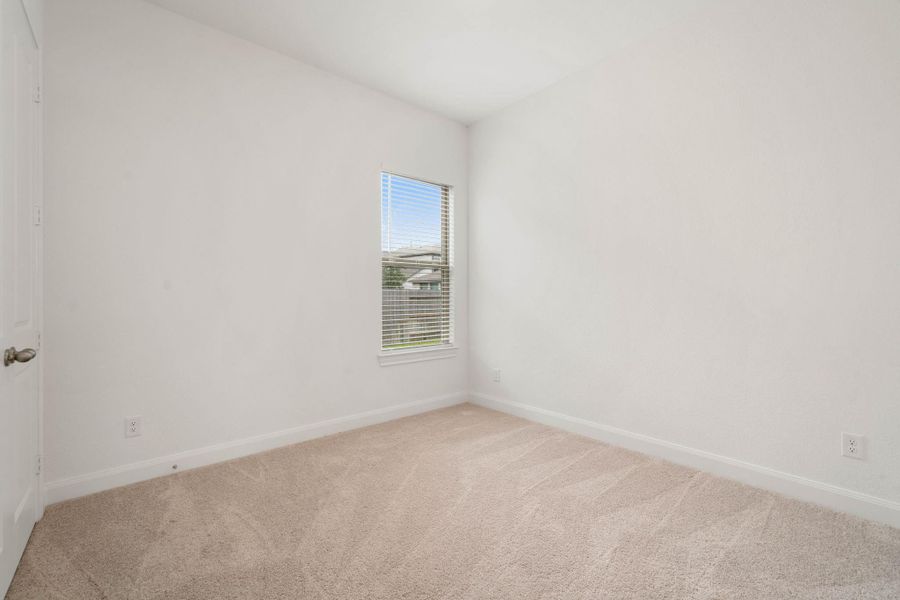 This is the secondary bedroom that is located on the main floor. It has its own bathroom attached and great for a guest room, a little one that needs to be nearby, or multi-generational use.
