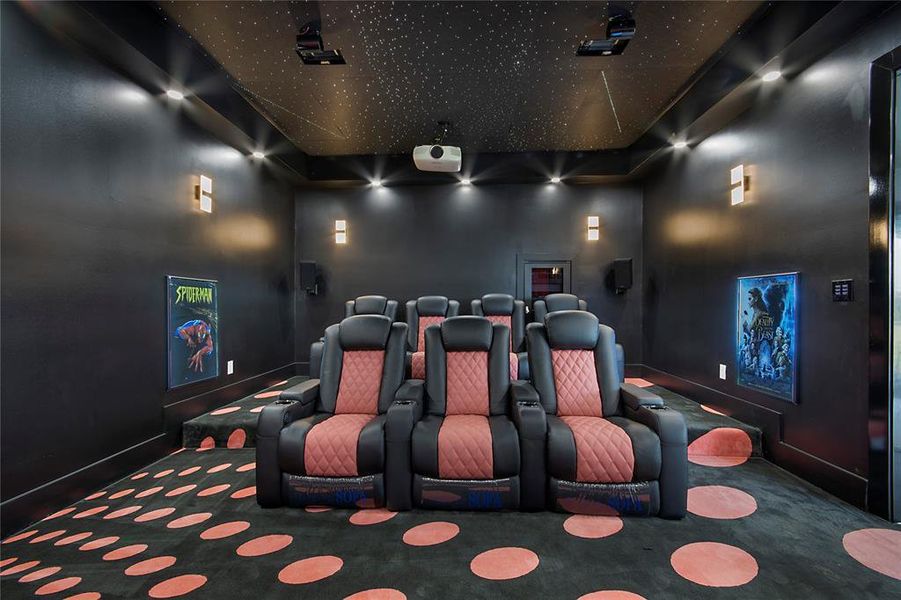 Cinema room featuring carpet and baseboards
