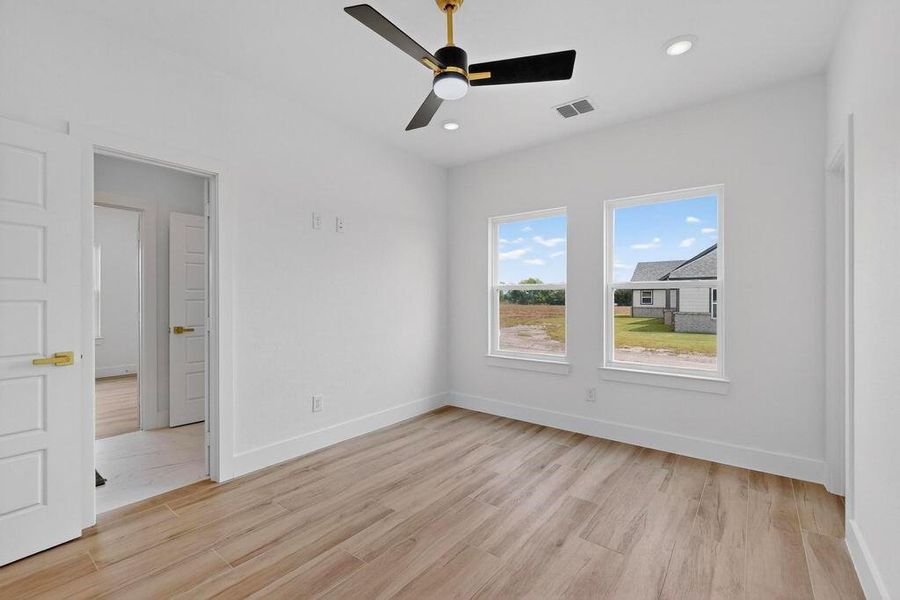 Unfurnished bedroom with light wood-type flooring, a ceiling fan, and recessed lighting
