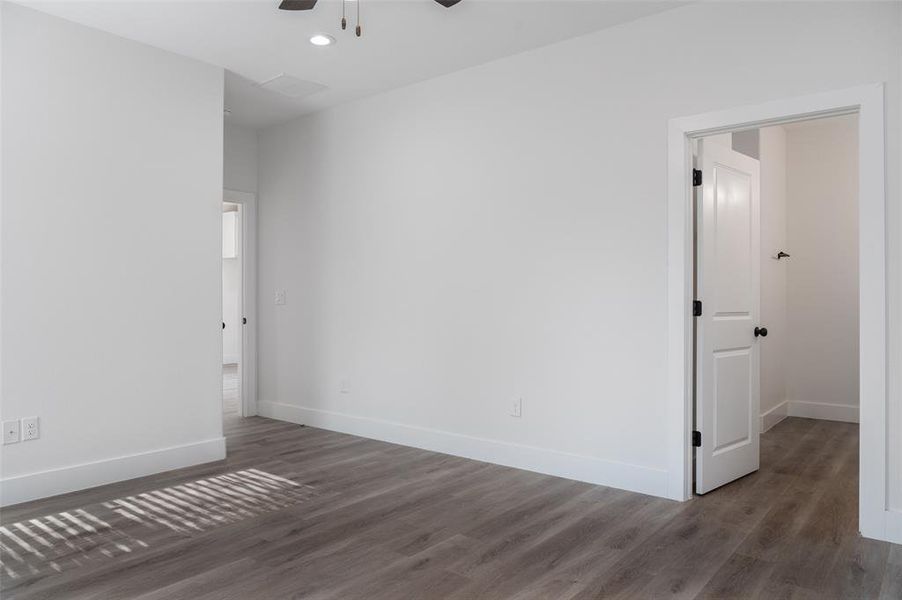 Spare room featuring ceiling fan and dark hardwood / wood-style floors