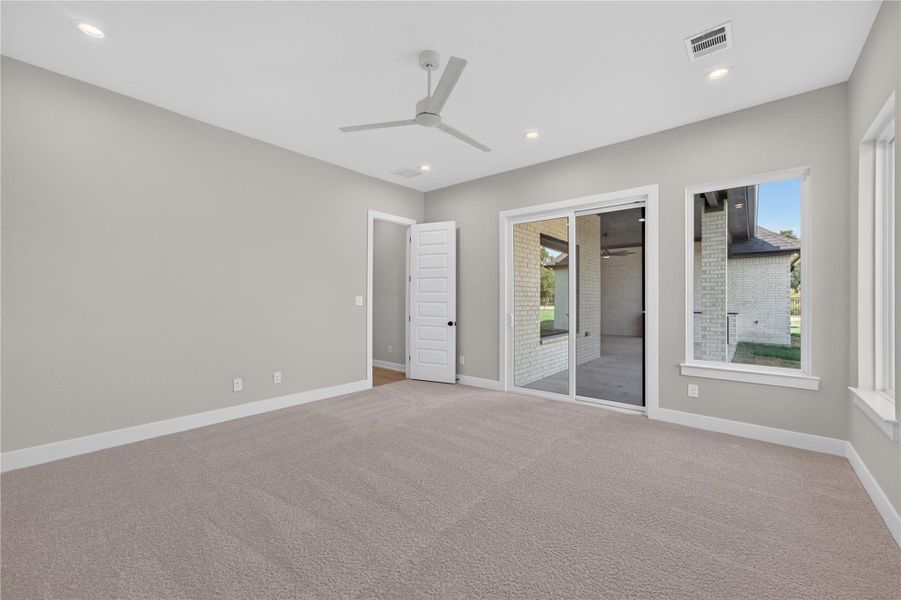 Plush carpeting and large sliding glass doors define this serene, open room.