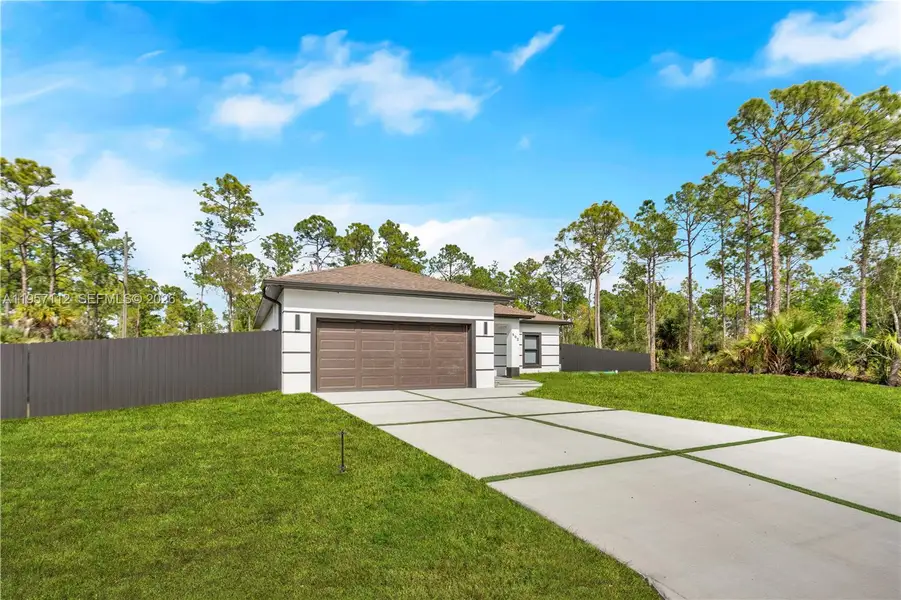 Front exterior of a new home in , Lehigh Acres, FL, highlighting curb appeal (Image 19).
