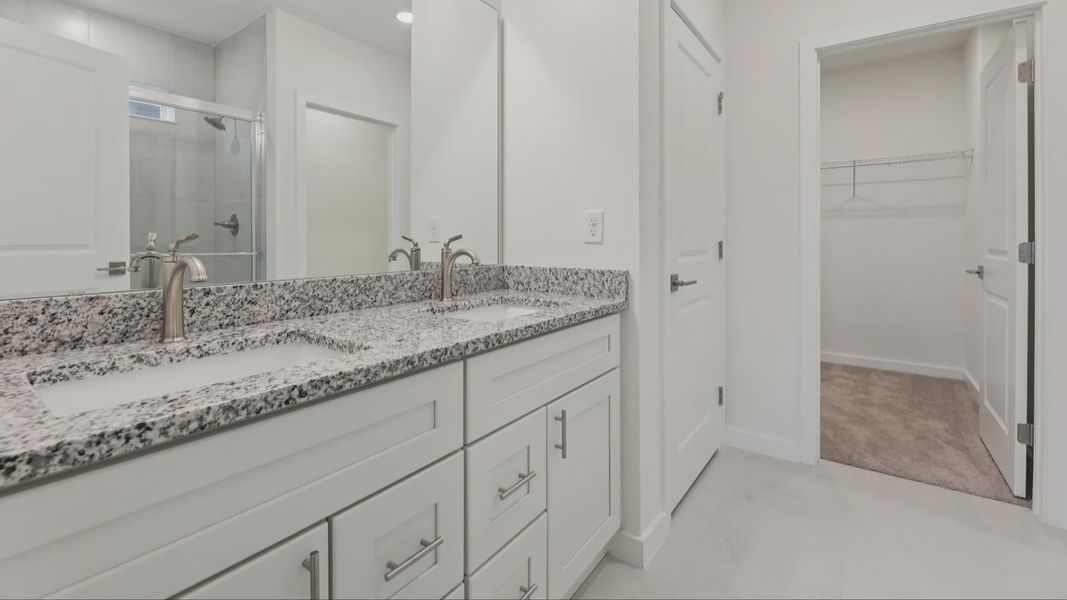 Primary Suite Bath with Dual Sinks in the Naples Floor Plan by DRB Homes Primary Suite Bath with Dual Sinks in the Naples Floor Plan by DRB Homes