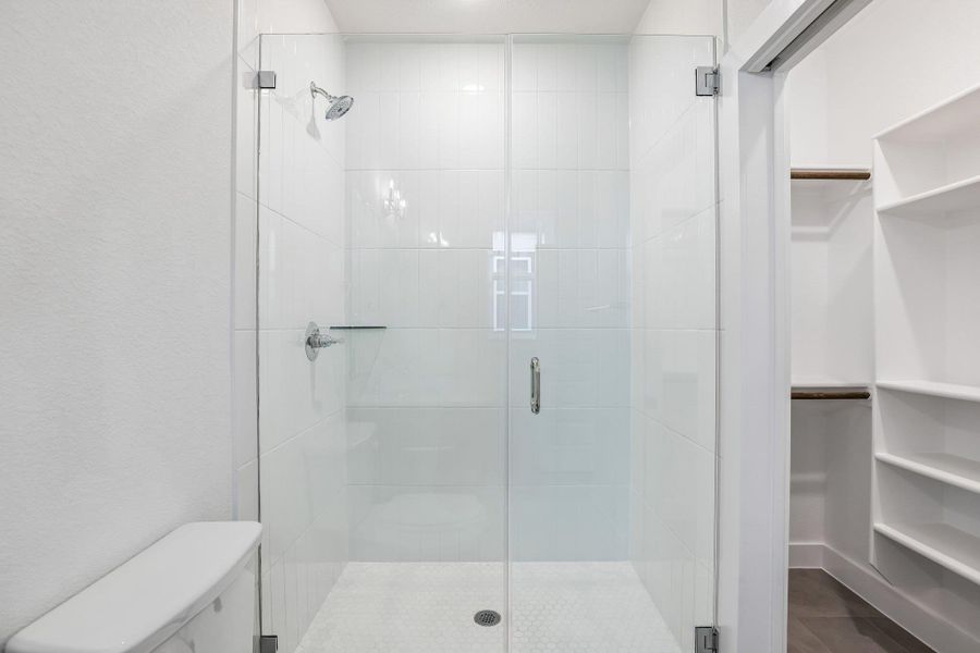 And an oversizedwalk in shower with subway tilesurround that's enclosed byframeless glass. Your access to the walk-in closet is through the bathroom.
