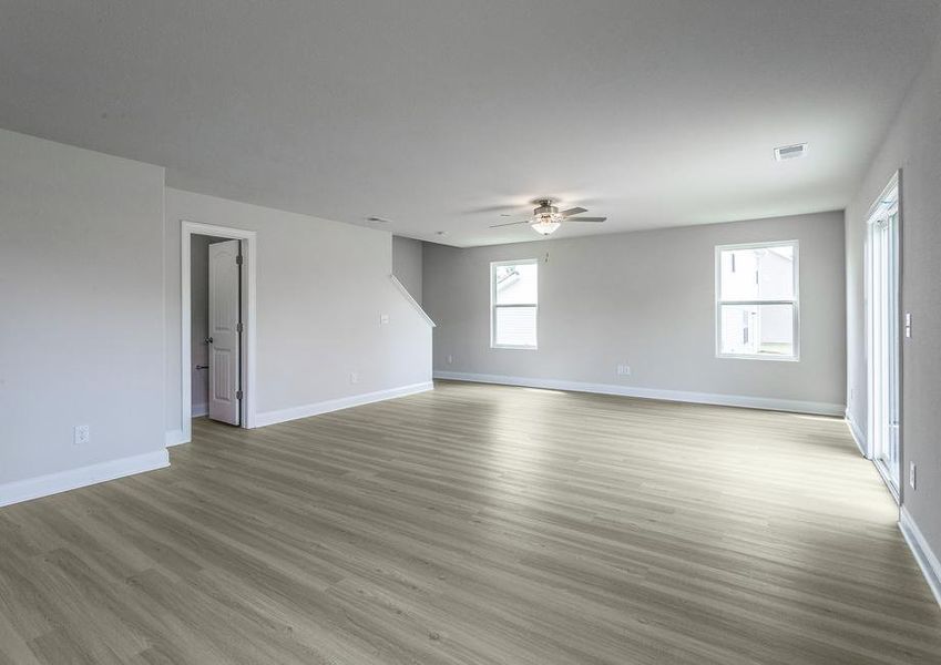 Living room with vinyl flooring and a ceiling fan.