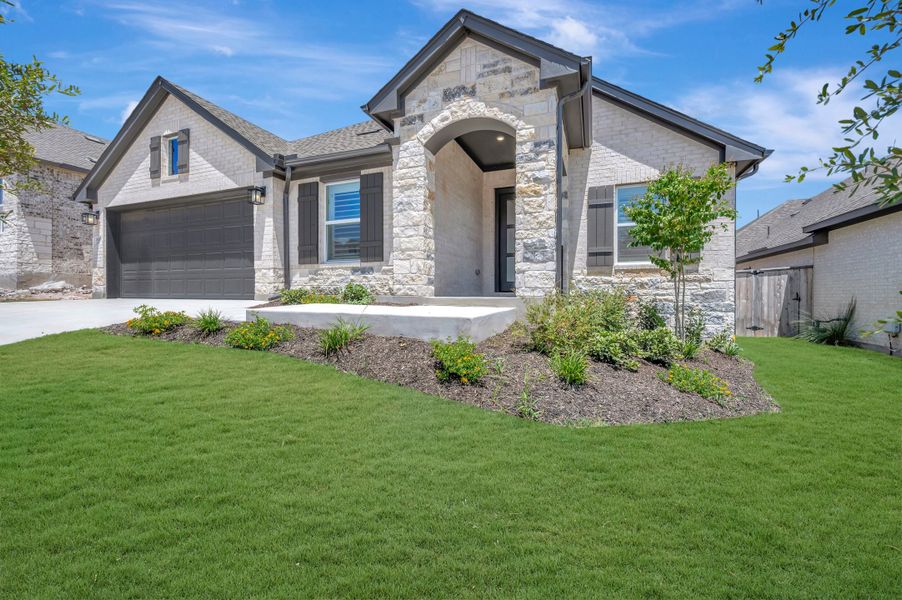 Front exterior of a new home in La Cima, San Marcos, TX, highlighting curb appeal (Image 22).