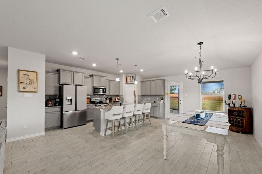 Dining space featuring recessed lighting, a chandelier, and light wood-type flooring