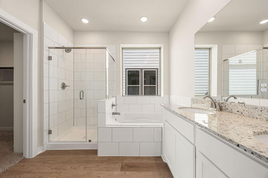 This spa-inspired bathroom showcases dual sinks, a spacious vanity, and a soaking tub beside a large window for natural light. The sleek finishes and neutral palette offer a calm, modern retreat. This spa-inspired bathroom showcases dual sinks, a spacious vanity, and a soaking tub beside a large window for natural light. The sleek finishes and neutral palette offer a calm, modern retreat.