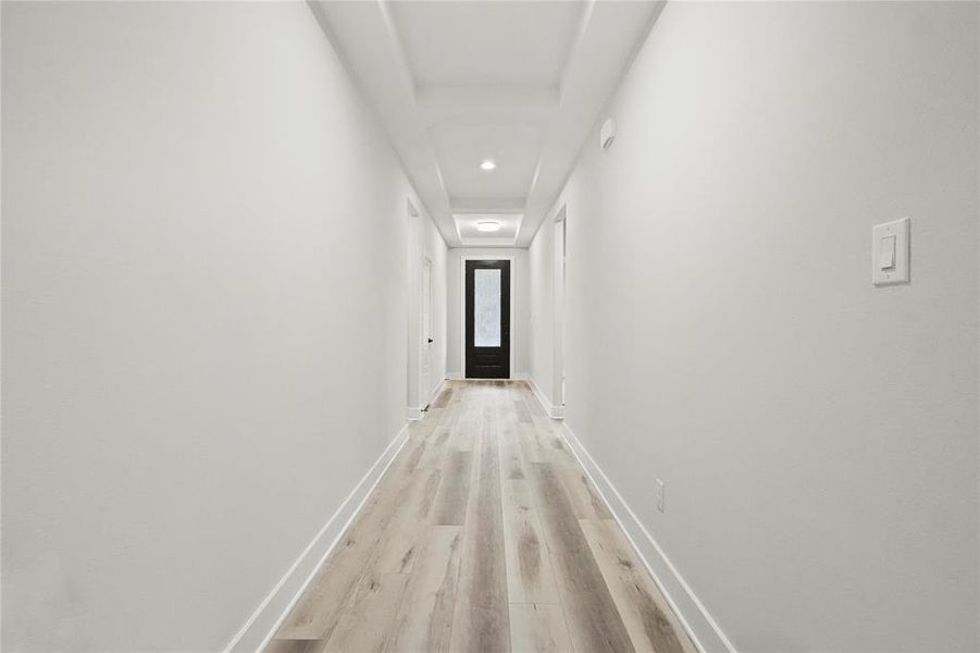 Hallway with light hardwood / wood-style flooring