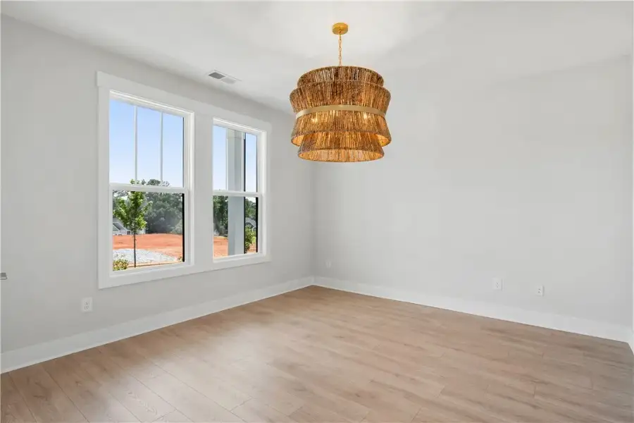 A warm glow emanates from the tiered chandelier in A warm glow emanates from the tiered chandelier in