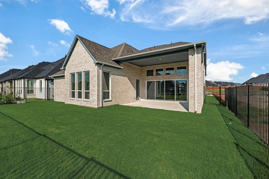 Rear view of property featuring a patio area, a fenced backyard, brick siding, and a shingled roof Rear view of property featuring a patio area, a fenced backyard, brick siding, and a shingled roof