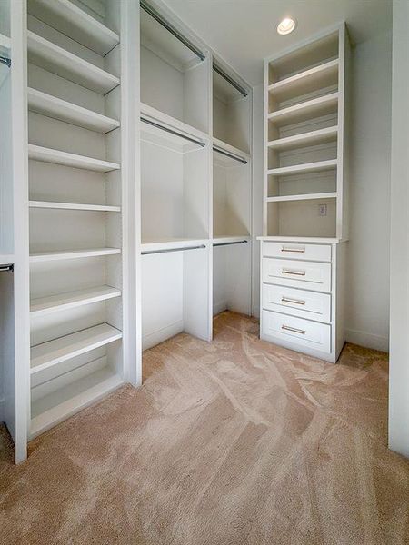 Custom closet system featuring built-in shelving, multiple hanging rods, and integrated drawers with contemporary hardware