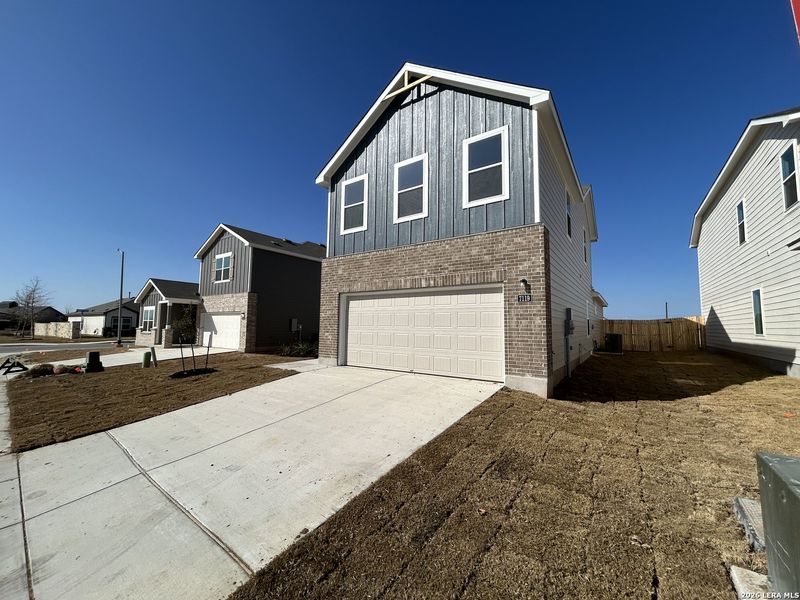 Front exterior of a new home in Hennersby Hollow, San Antonio, TX, highlighting curb appeal (Image 20).
