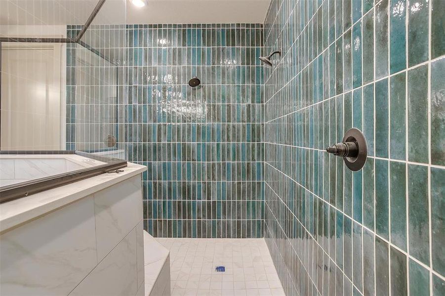 Bathroom with a tile shower and tile walls