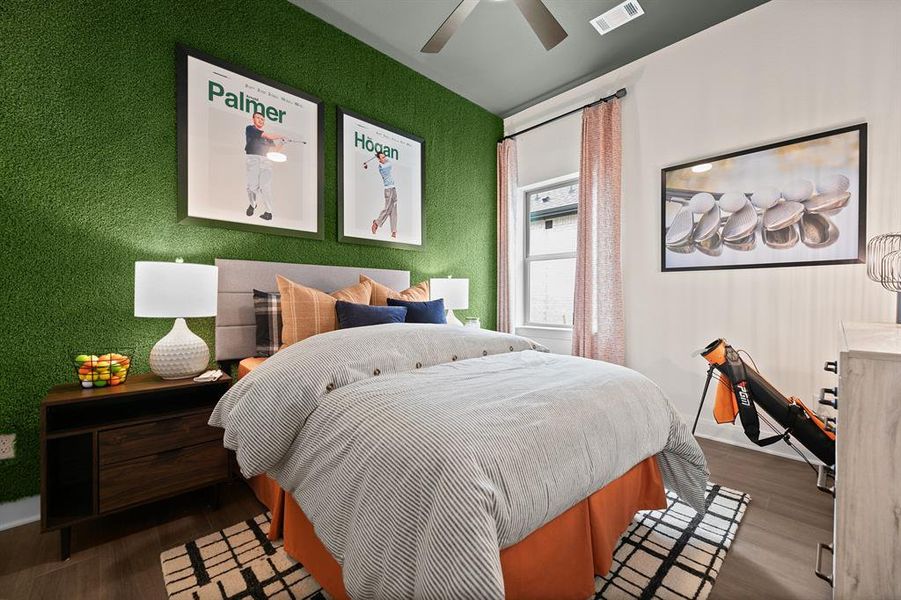 Bedroom with wood finished floors, a ceiling fan, and a textured wall Bedroom with wood finished floors, a ceiling fan, and a textured wall