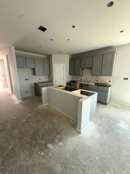 A spacious kitchen with an island awaits your finishing touches. A spacious kitchen with an island awaits your finishing touches.