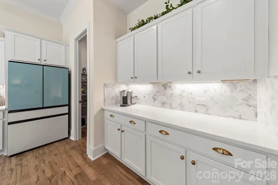 Kitchen Cabinets with Gold Hardware and Under Cabinet Light Strips