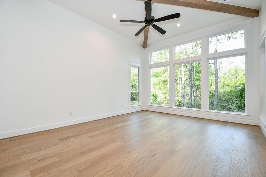 Retreat to the spacious primary suite, where comfort meets elegance. Soft natural light filters through large windows, highlighting the tray ceiling and serene color palette. With enough room for a king-sized bed and sitting area, this suite is the perfect personal sanctuary. Retreat to the spacious primary suite, where comfort meets elegance. Soft natural light filters through large windows, highlighting the tray ceiling and serene color palette. With enough room for a king-sized bed and sitting area, this suite is the perfect personal sanctuary.