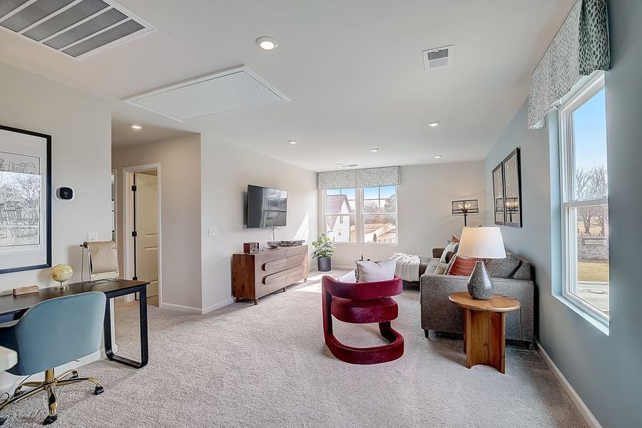 A living room with a tv and chairs.