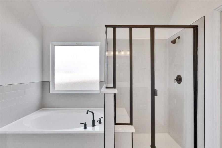 Full bathroom featuring a bath and a stall shower Full bathroom featuring a bath and a stall shower