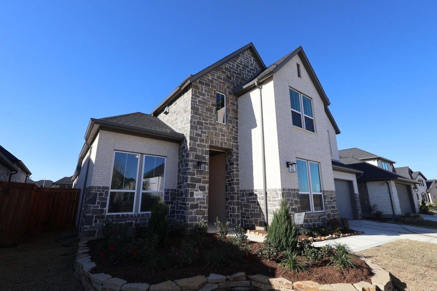 Front exterior of a new home in Dunham Pointe, Cypress, TX, highlighting curb appeal (Image 17). Front exterior of a new home in Dunham Pointe, Cypress, TX, highlighting curb appeal (Image 17).