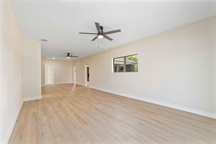 Unfurnished room featuring light wood finished floors and a ceiling fan Unfurnished room featuring light wood finished floors and a ceiling fan