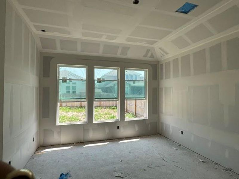 A new construction room features multiple windows, offering abundant natural light and views of the neighborhood.