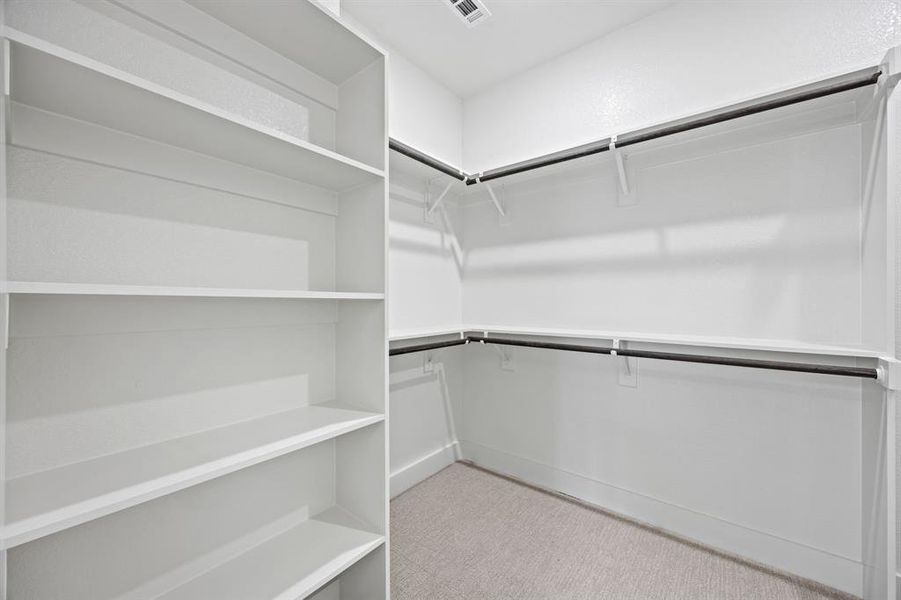 Walk in closet with light colored carpet Walk in closet with light colored carpet