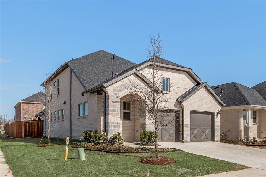 Front exterior of a new home in Spiritas Ranch, Little Elm, TX, highlighting curb appeal (Image 21).