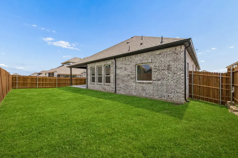 Exterior details and patio area of a home in Country Lakes, Denton (Image 22).