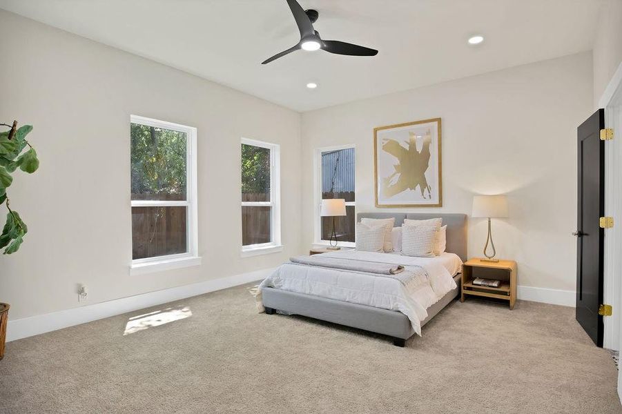 Primary bedroom featuring ceiling fan