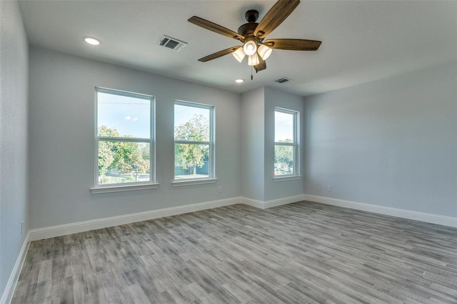 Empty room featuring light hardwood / wood-style flooring and ceiling fan