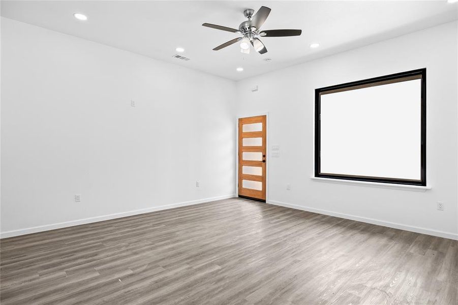 Spare room with hardwood / wood-style floors and ceiling fan