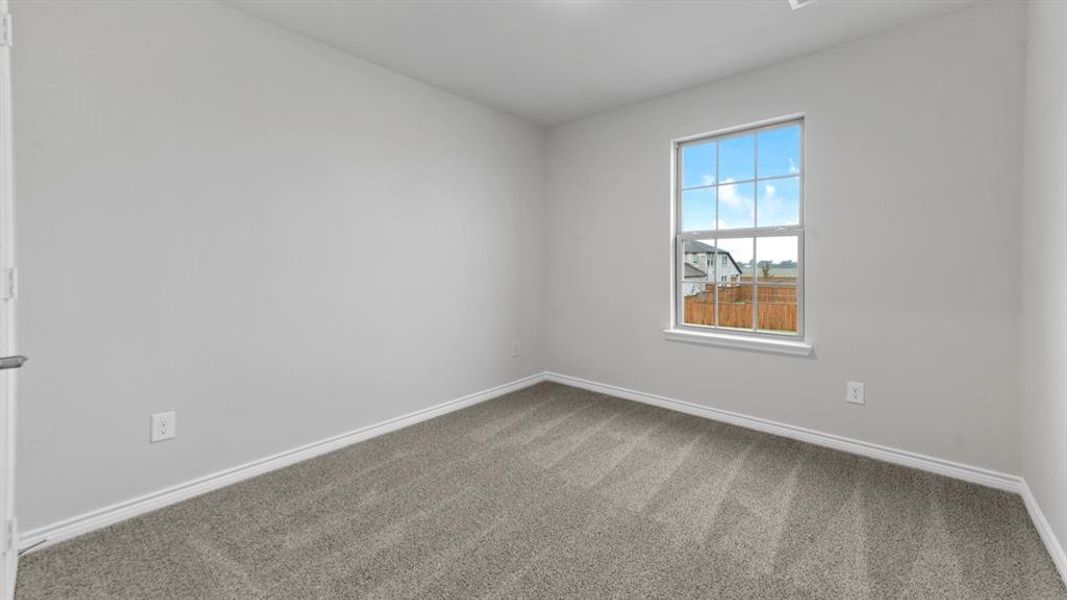Neutral tone wall paint, white trim, and gray patterned carpet create a versatile interior palette