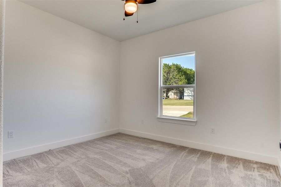Unfurnished room with light carpet and ceiling fan