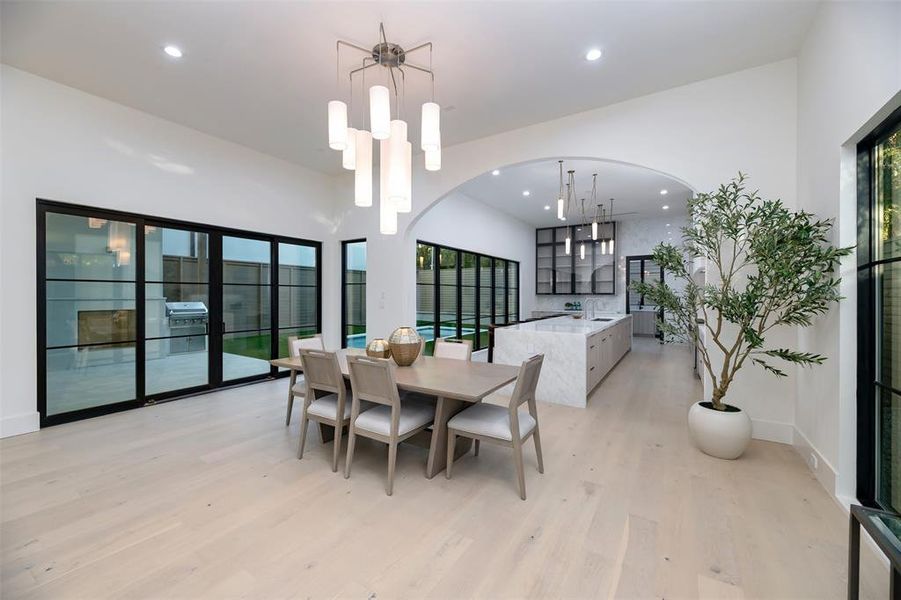 Dining space with recessed lighting and light wood-type flooring