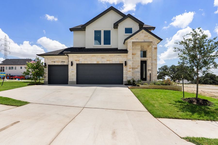 Front exterior of a new home in Foxfield, Austin, TX, highlighting curb appeal (Image 16). Front exterior of a new home in Foxfield, Austin, TX, highlighting curb appeal (Image 16).