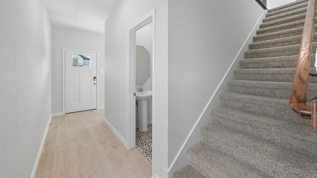 Stairway featuring baseboards and wood finished floors