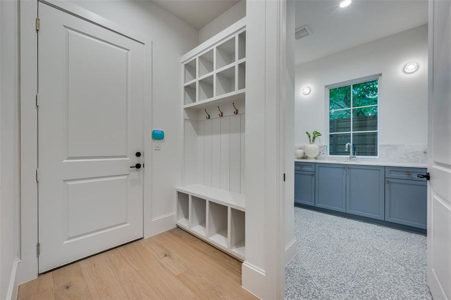 Mudroom featuring light wood-type flooring and recessed lighting
