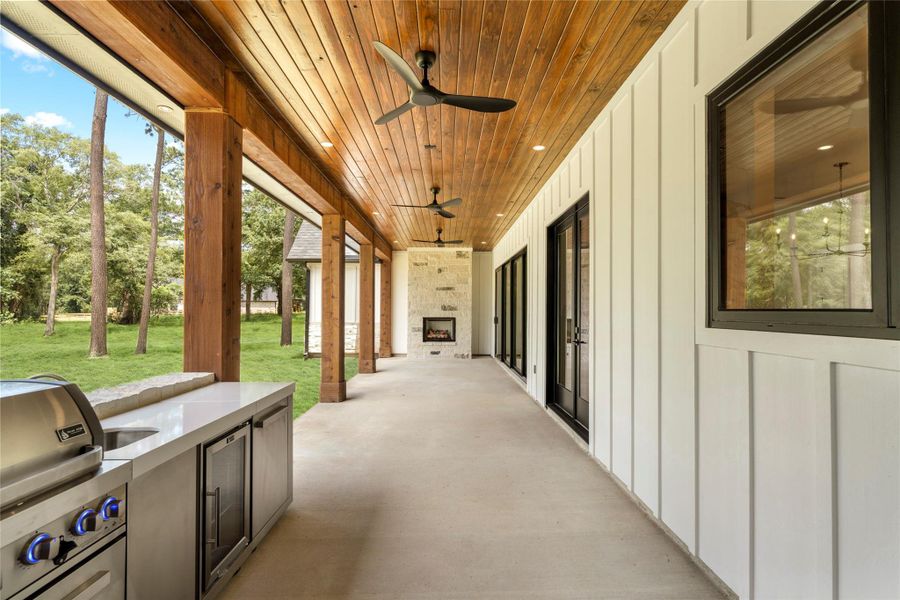 Outdoor stone gas fireplace on the covered patio. Outdoor stone gas fireplace on the covered patio.