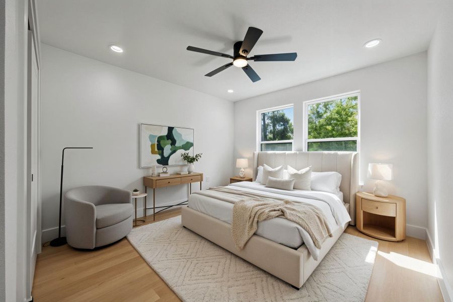Virtually staged Bedroom with light wood-style floors, recessed lighting, ceiling fan, and a baseboard radiator Virtually staged Bedroom with light wood-style floors, recessed lighting, ceiling fan, and a baseboard radiator