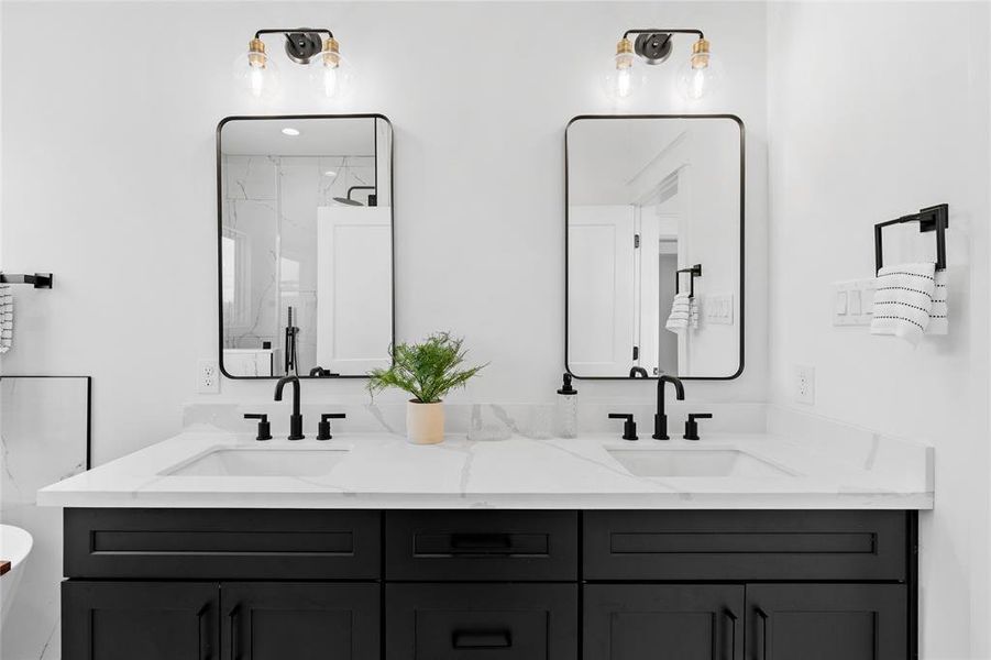 The sleek cabinetry in a bold color serves as a striking accent in the primary bath, complemented by separate sleek mirrors and fixtures boasting matte finishes, adding a touch of modern elegance to the space.