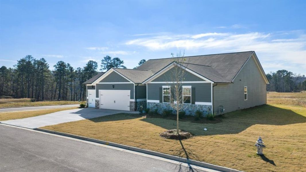 Front exterior of a new home in Fairway 17 at Mirror Lake, Villa Rica, GA, highlighting curb appeal (Image 20).