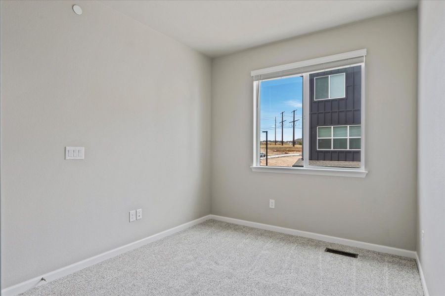 A room with a window and a view of the water.