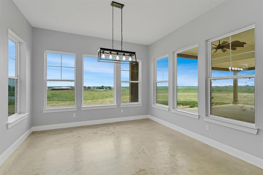 Unfurnished sunroom featuring a chandelier
