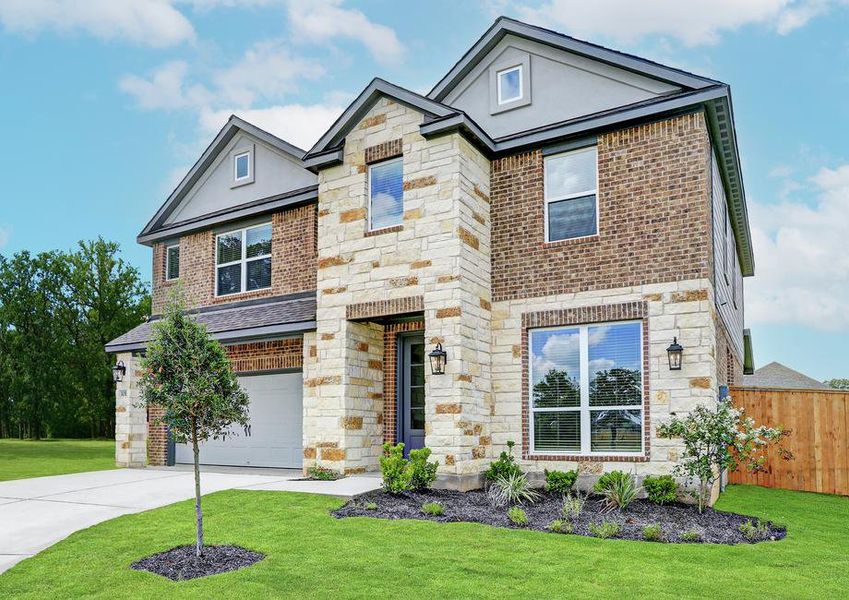 Angled exterior of the Sterling, highlighting the professional front yard landscaping, front windows, and gorgeous brick and stone.