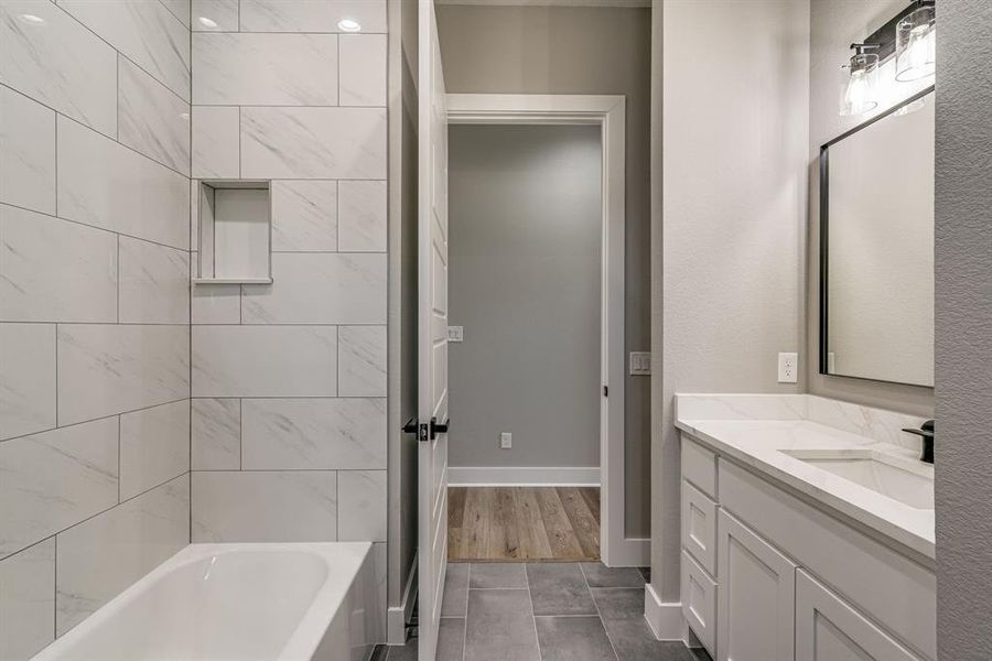 Bathroom featuring vanity, hardwood / wood-style floors, and a tub