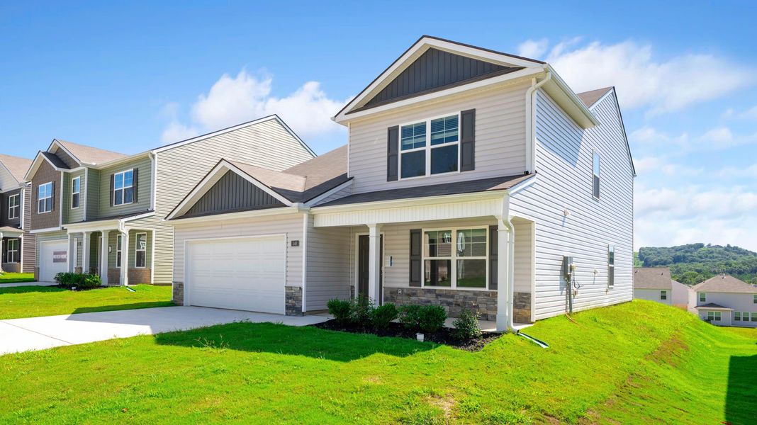 Front exterior of a new home in Hawk's Ridge, Rossville, GA, highlighting curb appeal (Image 1).